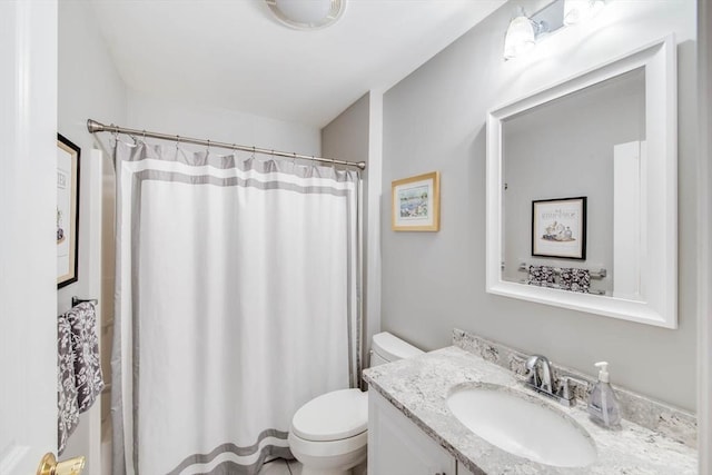 bathroom featuring vanity, toilet, and curtained shower