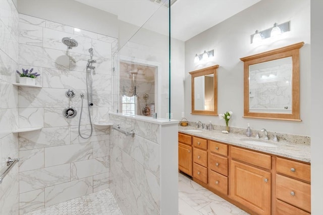 bathroom with vanity and tiled shower