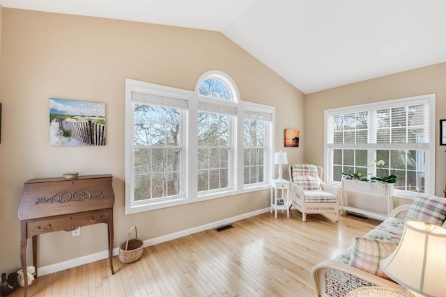 sitting room with hardwood / wood-style flooring and lofted ceiling