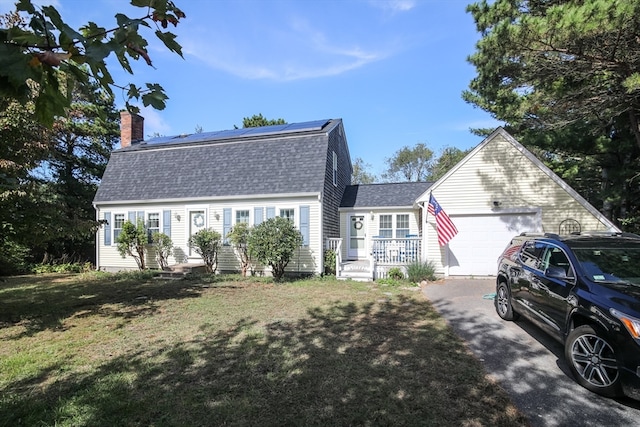 view of front of house with a front yard and a garage