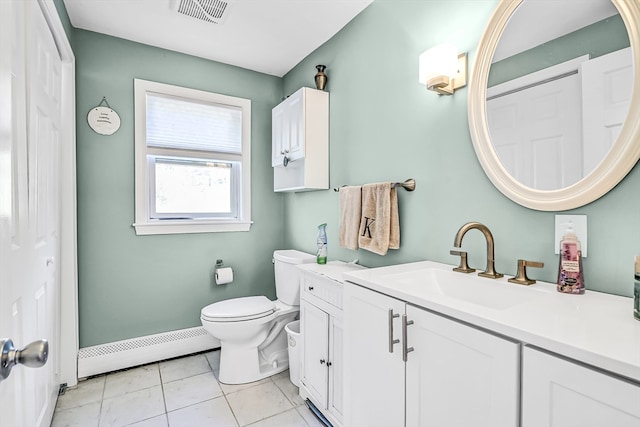 bathroom featuring tile patterned floors, baseboard heating, vanity, and toilet