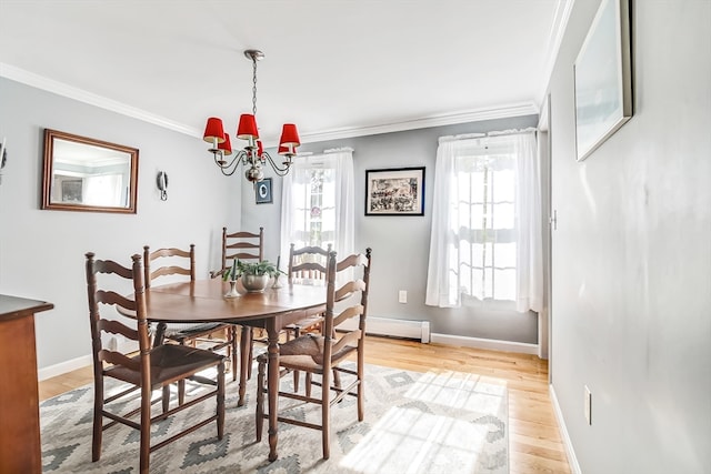 dining space with a notable chandelier, light wood-type flooring, baseboard heating, and crown molding