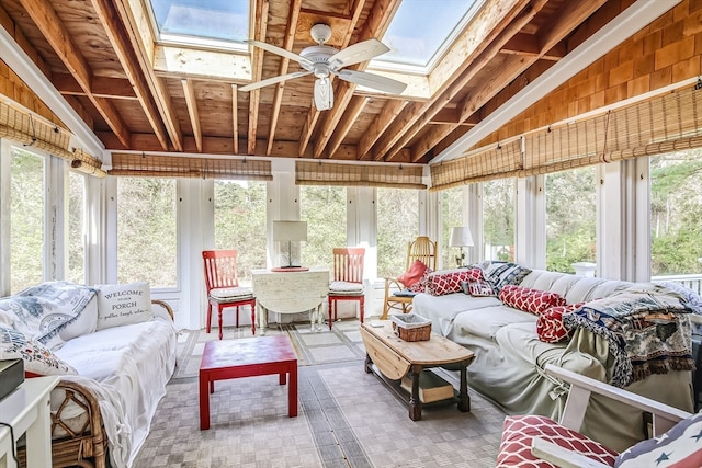 sunroom / solarium featuring a healthy amount of sunlight, lofted ceiling with skylight, and ceiling fan