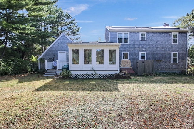 rear view of property with a lawn