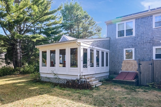 back of house with a lawn