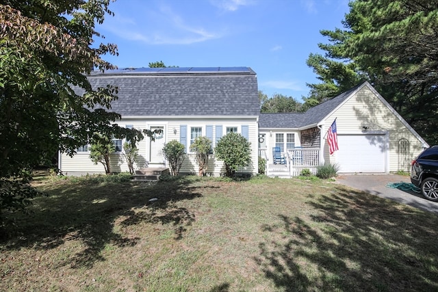 view of front of property with a front yard and a garage