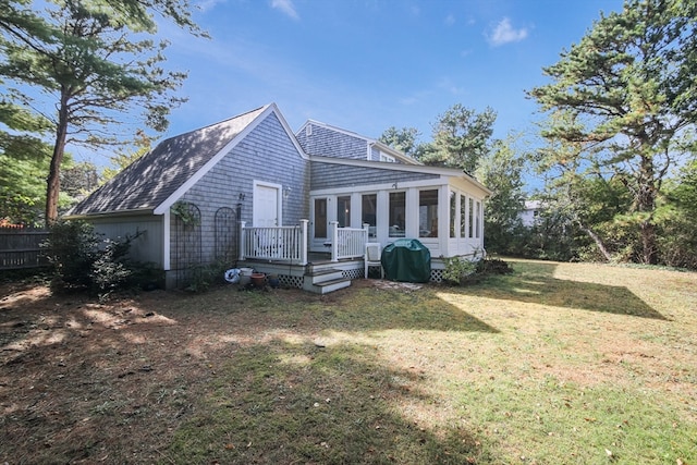 exterior space with a sunroom and a front lawn