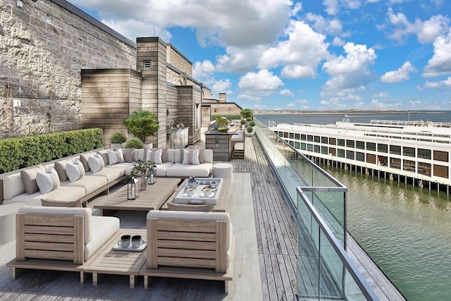 exterior space with an outdoor hangout area and a water view