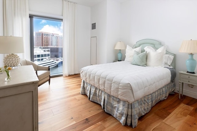 bedroom featuring light hardwood / wood-style flooring and access to outside