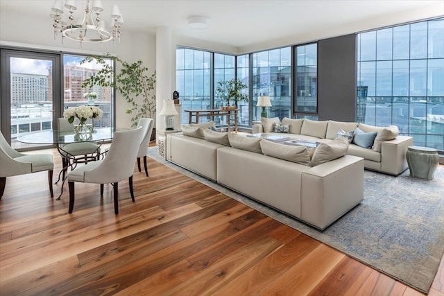 living room featuring a notable chandelier and light hardwood / wood-style flooring