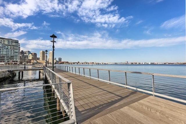 dock area featuring a water view and a view of city