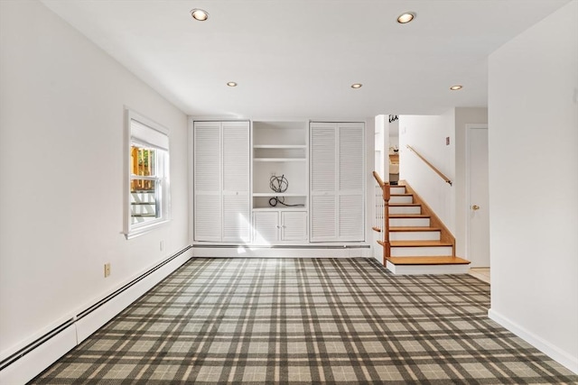 interior space featuring recessed lighting, baseboards, a baseboard heating unit, and stairway
