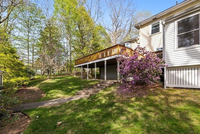 rear view of property with a yard and a wooden deck