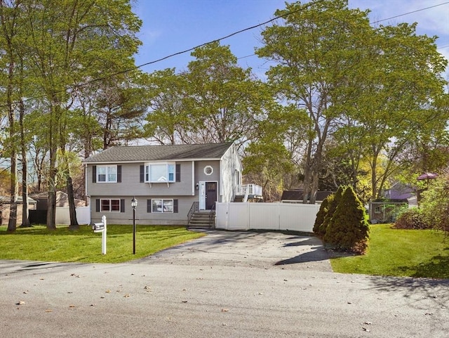 raised ranch with a front yard