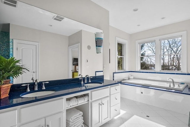 full bath with tile patterned flooring, visible vents, a sink, and double vanity