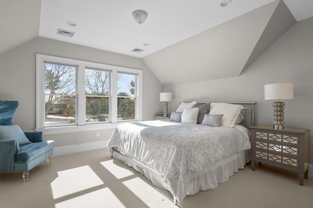 bedroom with visible vents, vaulted ceiling, and light carpet