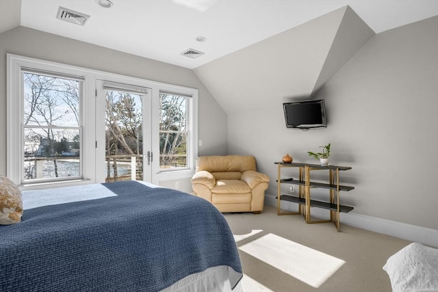 carpeted bedroom with lofted ceiling, visible vents, and baseboards