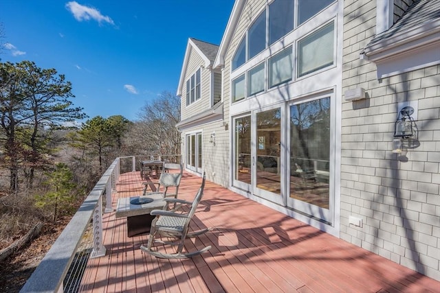 wooden terrace featuring outdoor dining area