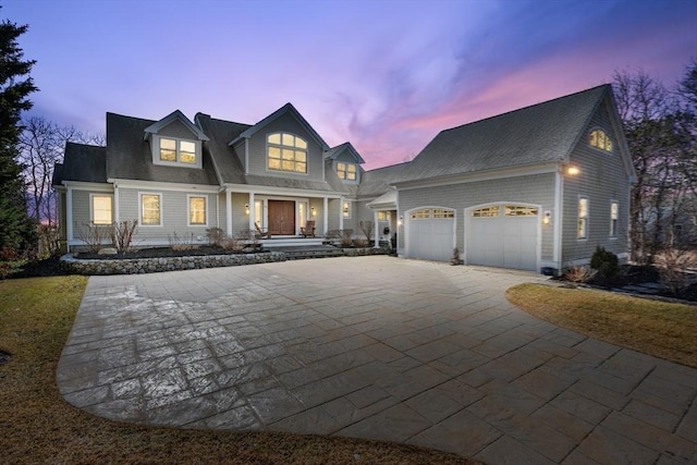 shingle-style home featuring a garage and concrete driveway