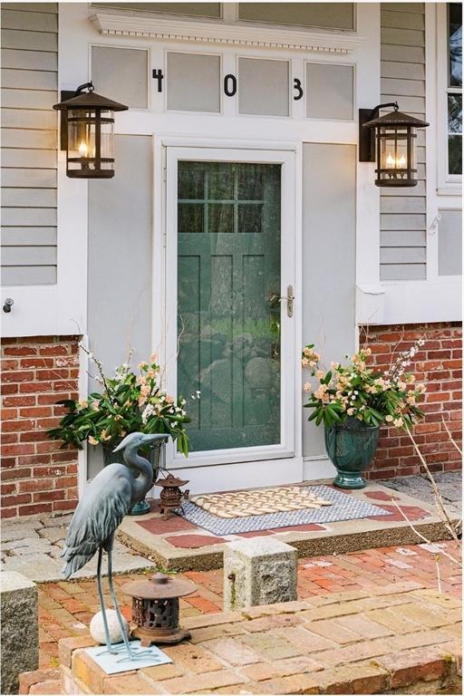 view of exterior entry with brick siding