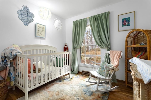 bedroom with wood finished floors and baseboards