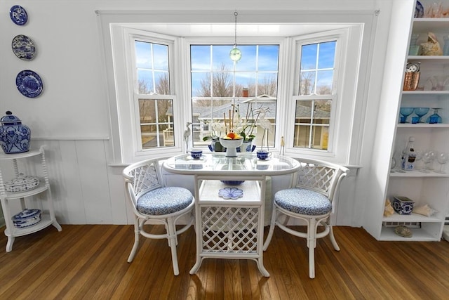 dining room featuring wood finished floors, wainscoting, and plenty of natural light