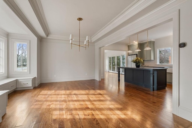 unfurnished dining area with ornamental molding, light hardwood / wood-style flooring, and a chandelier