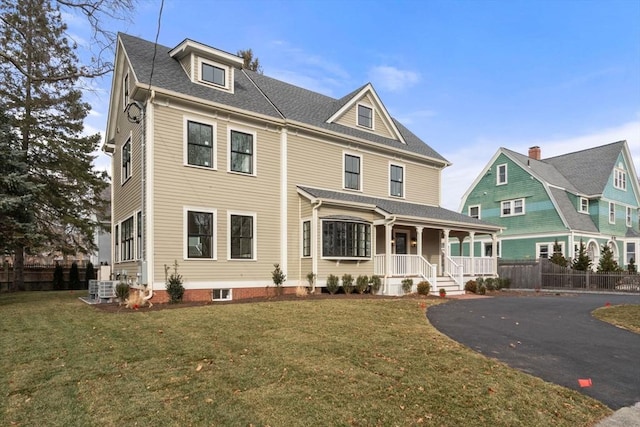 view of front of house with a porch and a front yard