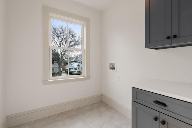 washroom with hookup for a washing machine and cabinets