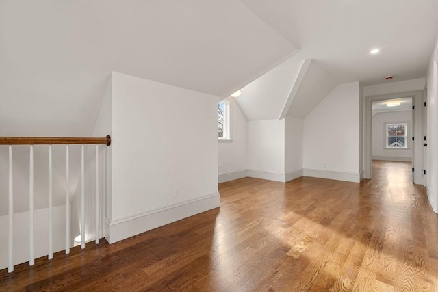 bonus room with hardwood / wood-style floors and lofted ceiling