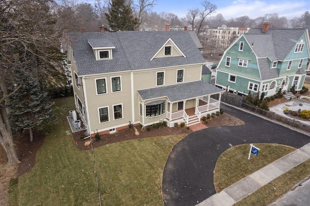 view of front of house with a porch and a front lawn