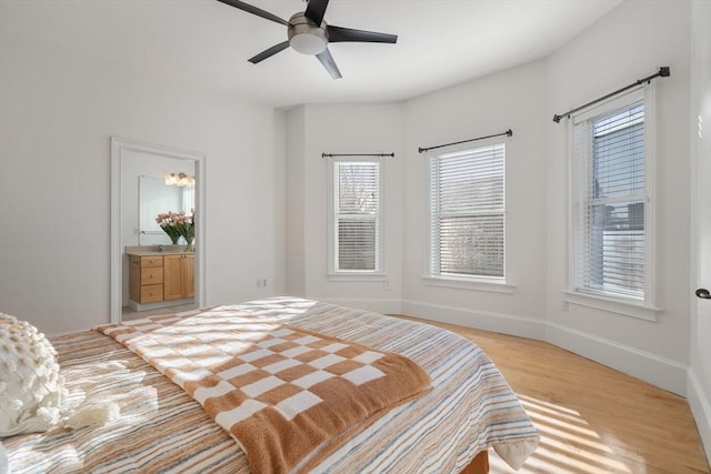 714 E 4th St Unit 3, Boston, MA 02127 - bedroom with multiple windows, light wood-style floors, and baseboards