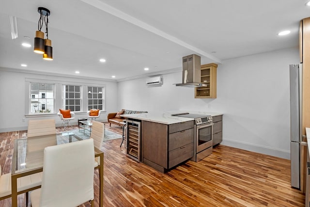 kitchen featuring beverage cooler, wall chimney range hood, dark hardwood / wood-style flooring, a wall unit AC, and stainless steel electric range