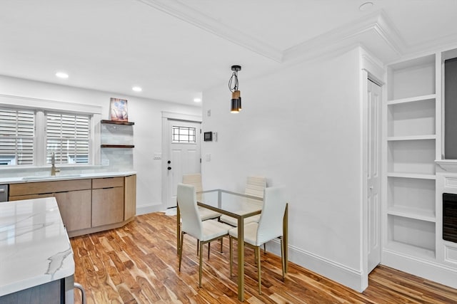 dining space with plenty of natural light, light wood-type flooring, and sink