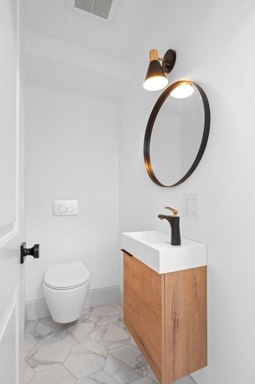 bathroom with vanity and toilet