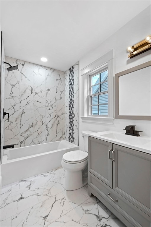 full bathroom with vanity, toilet, and tiled shower / bath