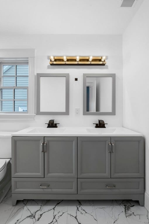 bathroom featuring vanity and toilet