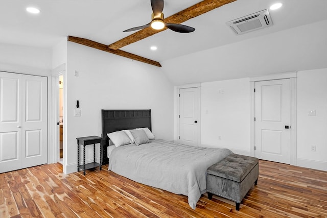 bedroom with vaulted ceiling with beams, ceiling fan, and wood-type flooring