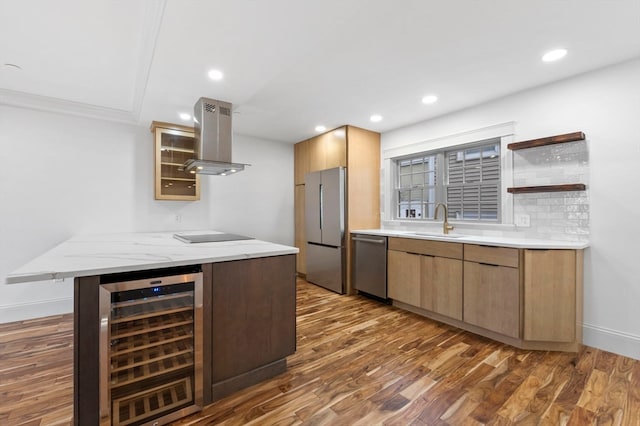 kitchen featuring stainless steel appliances, island range hood, beverage cooler, dark wood-type flooring, and sink