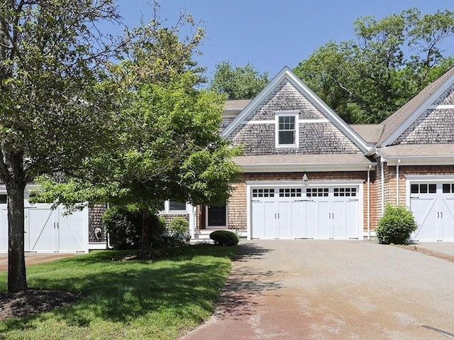 116 Spring Mdw Unit 116, Hanover, MA 02339 - view of front of home featuring concrete driveway, brick siding, and an attached garage