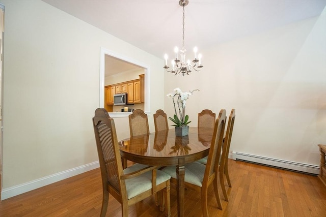 116 Spring Mdw Unit 116, Hanover, MA 02339 - dining space with baseboard heating, a chandelier, light wood-style floors, and baseboards