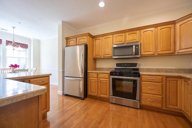 116 Spring Mdw Unit 116, Hanover, MA 02339 - kitchen featuring stainless steel appliances, light countertops, ornamental molding, light wood-style floors, and pendant lighting