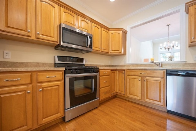 116 Spring Mdw Unit 116, Hanover, MA 02339 - kitchen featuring stainless steel appliances, ornamental molding, a chandelier, light wood-style floors, and light countertops