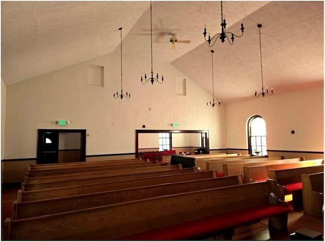 misc room featuring high vaulted ceiling, a chandelier, and a textured ceiling