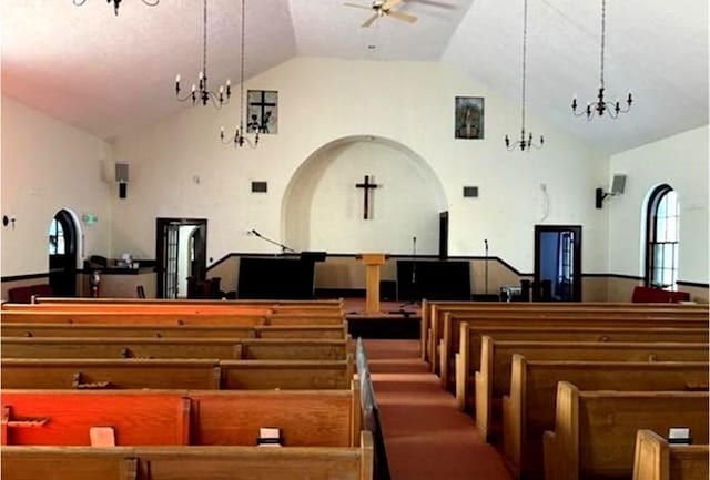 misc room with ceiling fan, high vaulted ceiling, a chandelier, and arched walkways