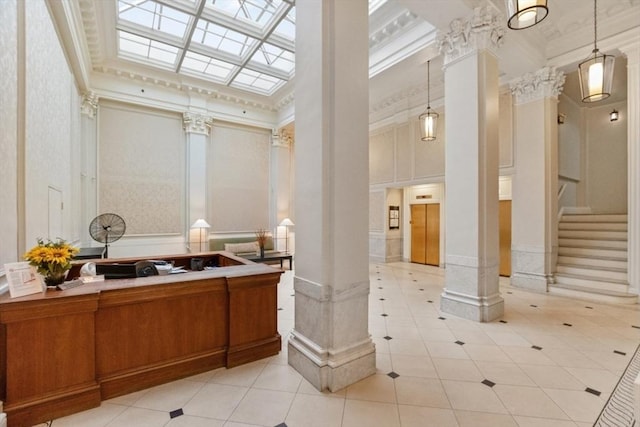 bathroom featuring a towering ceiling, decorative columns, tile patterned flooring, and vanity