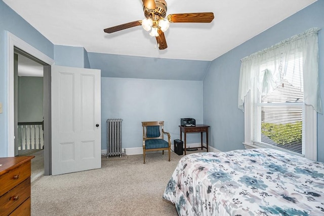 bedroom with radiator, carpet flooring, lofted ceiling, and a ceiling fan
