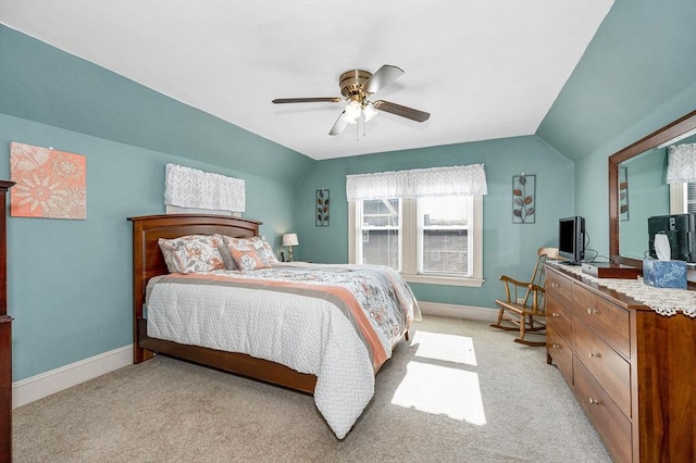bedroom featuring baseboards, lofted ceiling, ceiling fan, and light colored carpet