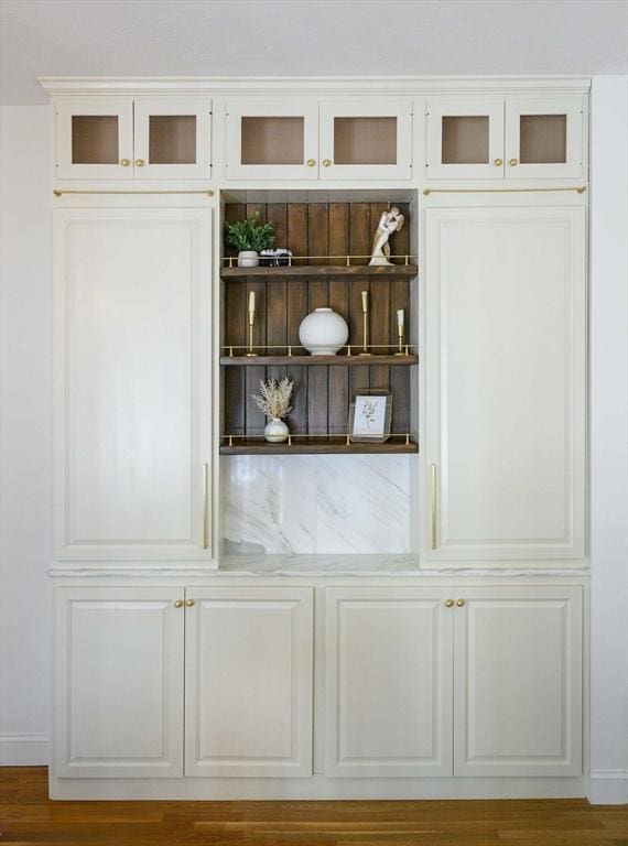 interior space featuring baseboards and wood finished floors