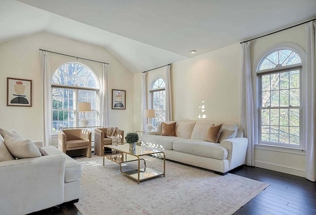 living area with vaulted ceiling, baseboards, dark wood finished floors, and a healthy amount of sunlight